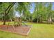 Lush backyard featuring a playground with slide and swing set at 730 Mount Oglethorpe Trl, Alpharetta, GA 30022