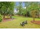 Expansive backyard with lush green lawn, wooden playground set and chairs at 730 Mount Oglethorpe Trl, Alpharetta, GA 30022