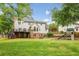 Spacious backyard featuring a deck, lush green lawn, and a charming playset for outdoor enjoyment at 730 Mount Oglethorpe Trl, Alpharetta, GA 30022