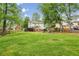 Sprawling backyard featuring ample green space, playground, and a view of the house at 730 Mount Oglethorpe Trl, Alpharetta, GA 30022