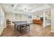 Open basement space offers a recreation area with table tennis, built-in shelving, and a separate seating area at 730 Mount Oglethorpe Trl, Alpharetta, GA 30022