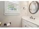 Cozy bathroom featuring a vanity, sink, and window with shutter style blinds at 730 Mount Oglethorpe Trl, Alpharetta, GA 30022