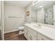 Bright bathroom featuring wood look floors, a large mirror, and white vanity at 730 Mount Oglethorpe Trl, Alpharetta, GA 30022