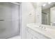 Bathroom featuring a glass enclosed shower, a white vanity with chrome fixtures, and a large, bright mirror at 730 Mount Oglethorpe Trl, Alpharetta, GA 30022