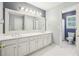 Bright bathroom features a double vanity with white cabinets, tile flooring, and a separate toilet area at 730 Mount Oglethorpe Trl, Alpharetta, GA 30022