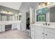 Modern bathroom with dual sinks, white cabinets, and a large mirror at 730 Mount Oglethorpe Trl, Alpharetta, GA 30022
