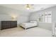 Light-filled bedroom features neutral walls, plush carpeting, a modern dresser, and window with shutter-style blinds at 730 Mount Oglethorpe Trl, Alpharetta, GA 30022