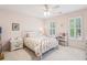 Cozy bedroom with neutral walls, a white iron bed frame, and light-filled windows with shutter-style blinds at 730 Mount Oglethorpe Trl, Alpharetta, GA 30022
