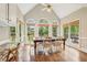 Dining area with vaulted ceiling, many windows overlooking the backyard, and wood floors at 730 Mount Oglethorpe Trl, Alpharetta, GA 30022