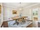 Elegant dining room featuring hardwood floors, a chandelier, and access to the kitchen at 730 Mount Oglethorpe Trl, Alpharetta, GA 30022