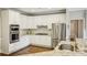 Bright kitchen with white cabinets, stainless steel appliances, and granite countertops at 730 Mount Oglethorpe Trl, Alpharetta, GA 30022
