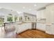 Eat-in kitchen featuring white cabinetry, granite counters, and stainless steel appliances at 730 Mount Oglethorpe Trl, Alpharetta, GA 30022