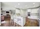 Open kitchen with white cabinets, granite countertops, island with seating and hardwood flooring at 730 Mount Oglethorpe Trl, Alpharetta, GA 30022