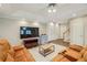 Cozy living room with ceiling fan, TV, neutral colors, and two sofas at 730 Mount Oglethorpe Trl, Alpharetta, GA 30022