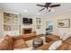 Inviting living room with a brick fireplace, built-in shelving, and comfortable seating at 730 Mount Oglethorpe Trl, Alpharetta, GA 30022