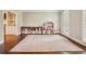 Playroom featuring hardwood floors, built-in shelving, and a large area rug at 730 Mount Oglethorpe Trl, Alpharetta, GA 30022