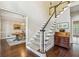 Welcoming staircase with hardwood floors and access to the dining room at 730 Mount Oglethorpe Trl, Alpharetta, GA 30022