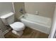 Bathroom featuring a toilet, bathtub, and neutral walls at 7562 Asbury Manor Dr, Lithonia, GA 30014