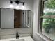 Modern bathroom vanity featuring a rectangular mirror, sleek faucet, and stylish lighting at 7562 Asbury Manor Dr, Lithonia, GA 30014