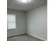 Cozy bedroom featuring neutral carpet, light gray walls, and natural light from the window at 7562 Asbury Manor Dr, Lithonia, GA 30014