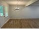 Inviting dining room featuring laminate flooring and a modern chandelier at 7562 Asbury Manor Dr, Lithonia, GA 30014