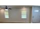 Living room featuring new flooring, neutral walls, two windows, and a modern front door at 7562 Asbury Manor Dr, Lithonia, GA 30014