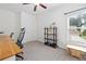 Versatile room with large window, ceiling fan, desk, and a storage shelf at 1998 Lakeview Bend Way, Buford, GA 30519