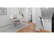Bright home office space with hardwood floors, white walls, and a staircase at 2001 Swazey Dr, Decatur, GA 30032