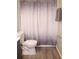 Bathroom featuring a toilet and a shower with a decorative gray and white shower curtain at 4190 Wingfoot Ct, Decatur, GA 30035