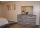Bedroom featuring a gray dresser, framed mirror, decorative accents, and neutral-toned walls at 4190 Wingfoot Ct, Decatur, GA 30035