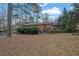Brick house with a large backyard surrounded by trees creating a private outdoor space at 4222 Webb Rd, Tucker, GA 30084