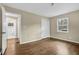 The bedroom showcases hardwood floors, a closet, and a view of the bathroom at 4222 Webb Rd, Tucker, GA 30084