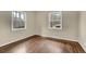 The bedroom features newly refinished hardwood floors and two large, bright windows at 4222 Webb Rd, Tucker, GA 30084