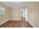 This room features hardwood floors, wood-paneled walls, and a window at 4222 Webb Rd, Tucker, GA 30084