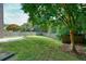 Spacious backyard features a well-maintained lawn, mature trees, and a wooden fence at 1265 Birchwood Ln, Roswell, GA 30076