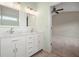 A bathroom with a vanity, a mirror, and view into a carpeted room at 1265 Birchwood Ln, Roswell, GA 30076