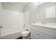 Clean bathroom with white vanity, mirror, toilet, and shower with white tile at 1265 Birchwood Ln, Roswell, GA 30076