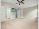 A Primary bedroom with a ceiling fan, a TV, access to a bathroom, and neutral carpet at 1265 Birchwood Ln, Roswell, GA 30076