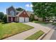 Two-story home with a brick facade, gray siding, a well-manicured lawn, and a two car garage at 1265 Birchwood Ln, Roswell, GA 30076