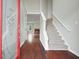Inviting entryway with hardwood floors, a staircase, and an open view to the living room with a fireplace at 1265 Birchwood Ln, Roswell, GA 30076