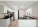 Modern kitchen with stainless steel appliances, granite countertops, and neutral tile flooring at 1265 Birchwood Ln, Roswell, GA 30076