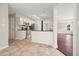 Open kitchen featuring stainless steel appliances, breakfast bar, and tile floors at 1265 Birchwood Ln, Roswell, GA 30076
