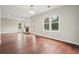 Bright living room with wood floors, fireplace, and large windows providing ample natural light at 1265 Birchwood Ln, Roswell, GA 30076