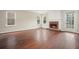 Well-lit living room boasts shiny hardwood floors, a brick fireplace, and access to the backyard at 1265 Birchwood Ln, Roswell, GA 30076