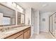 Elegant bathroom featuring double sinks, granite countertops, and glass-enclosed shower at 2325 Lake Cove Ct, Buford, GA 30519