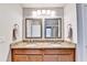 Bathroom featuring double sinks, granite countertops, and modern lighting at 2325 Lake Cove Ct, Buford, GA 30519