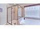 Bright bathroom featuring a glass enclosed shower, soaking tub and a light color palette at 2325 Lake Cove Ct, Buford, GA 30519