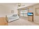 Well-lit bedroom with daybed, window, and decorative fan at 2325 Lake Cove Ct, Buford, GA 30519