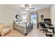 Well lit bedroom with a comfortable bed, desk, chair, and contemporary ceiling fan at 2325 Lake Cove Ct, Buford, GA 30519