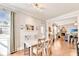 Bright dining area with natural light, wood floors, and an open-concept layout leading to the living room at 2325 Lake Cove Ct, Buford, GA 30519